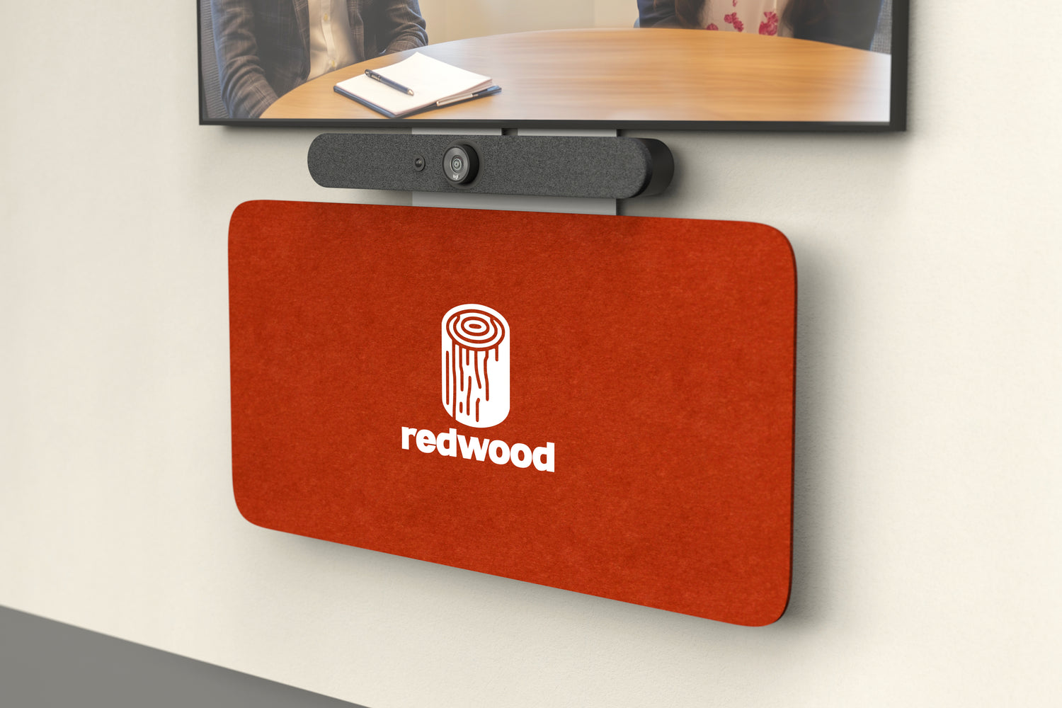 Heckler Credenza Neo with a custom "Redwood" brand logo on red felt, mounted below a video conference display — branded AV credenza.