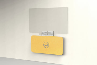 Heckler Credenza Neo in Mustard with custom logo — wall-mounted AV credenza with branded mustard-yellow acoustic felt panel concealing components below a display.