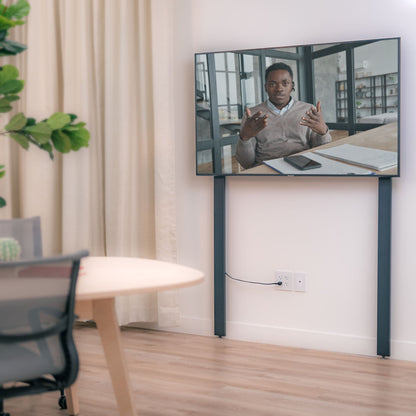 Heckler AV Wall Structure in a meeting space with people.