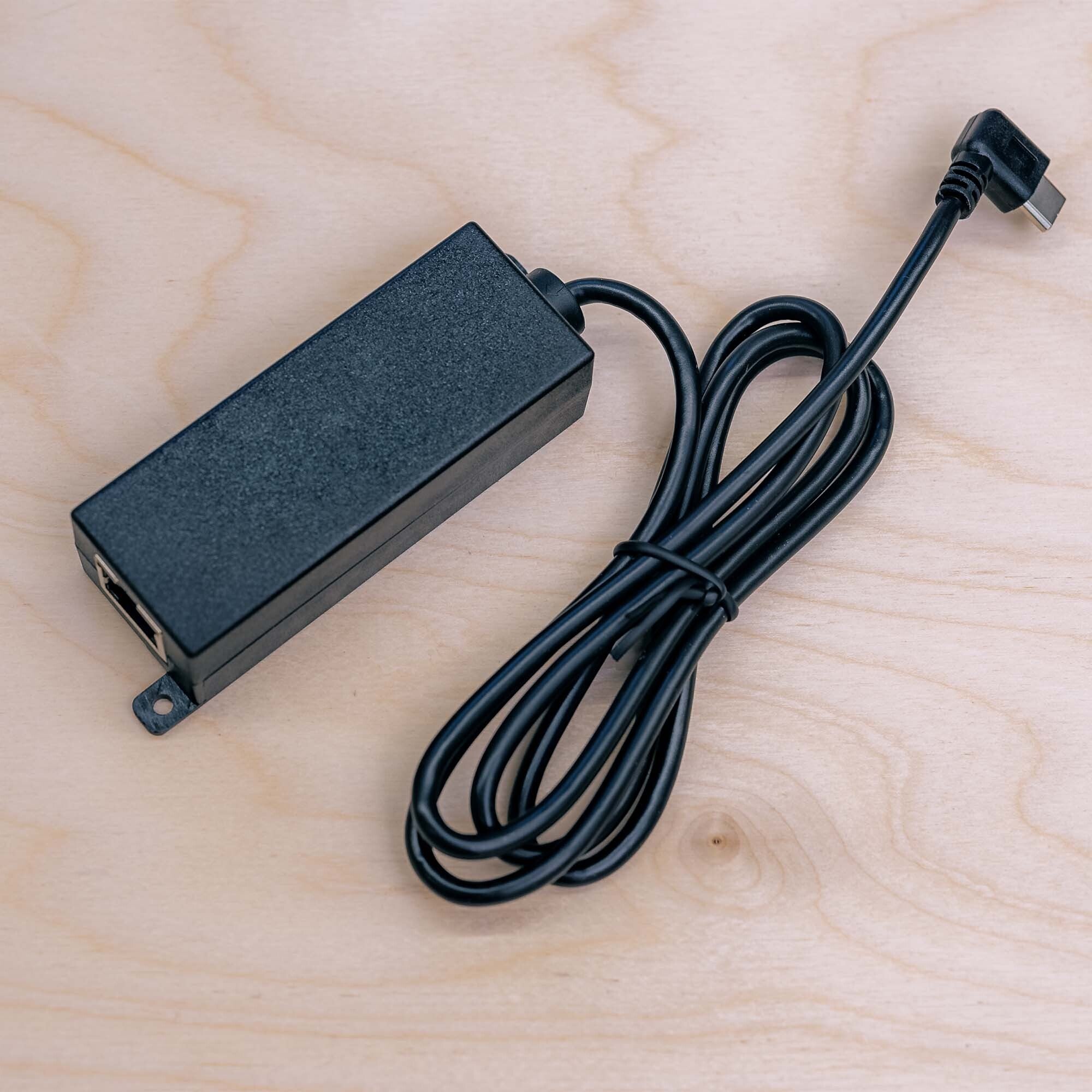 PoE to USB-C adapter T519, angle view showing compact form factor and LED indicators